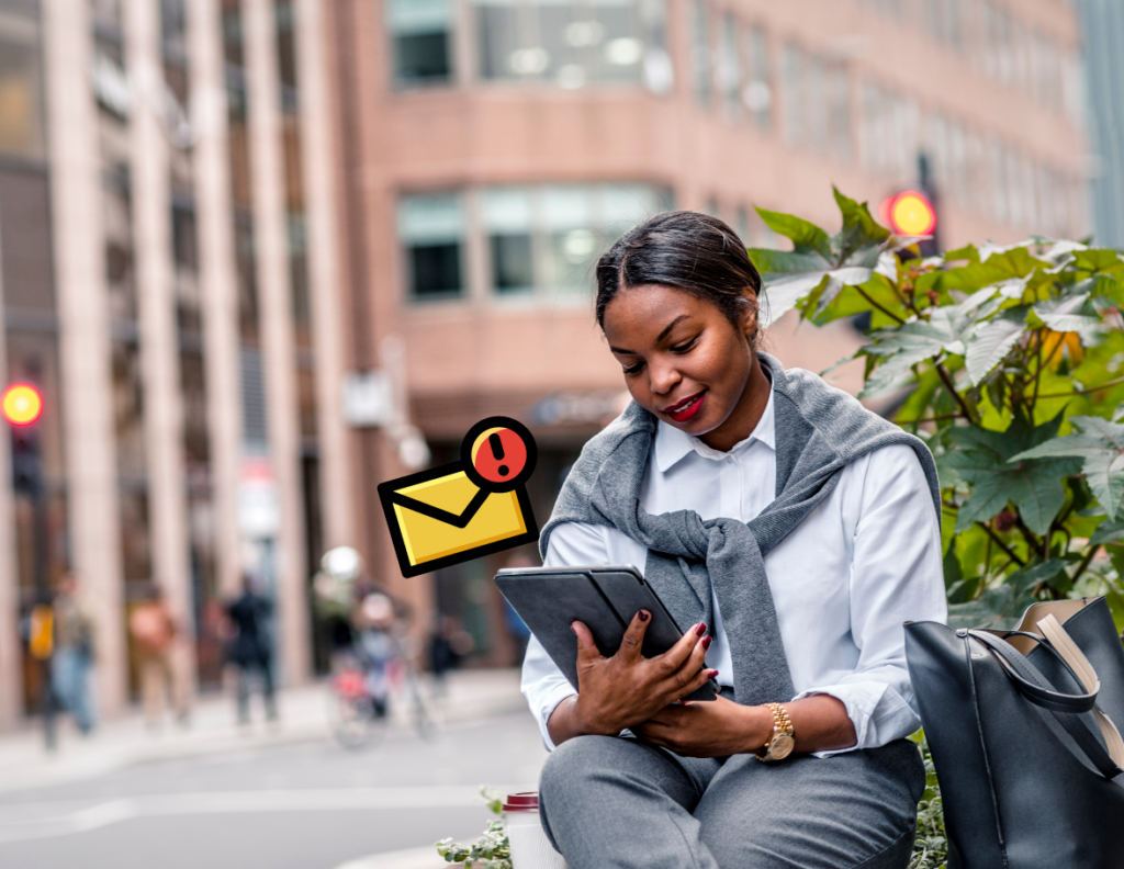 Woman looking down at an ipad with an email notification