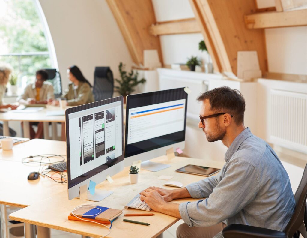 Man on desktop using business process automation tools