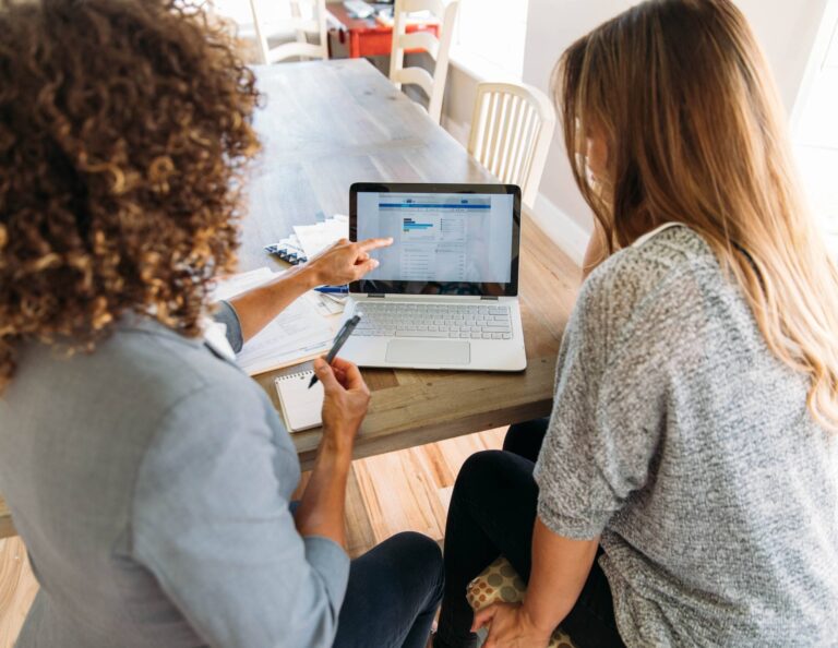 Two women looking at a computer screen