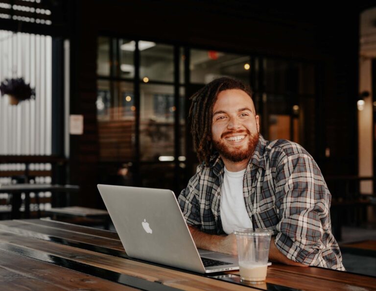 Smiling independent works at coffee shop.