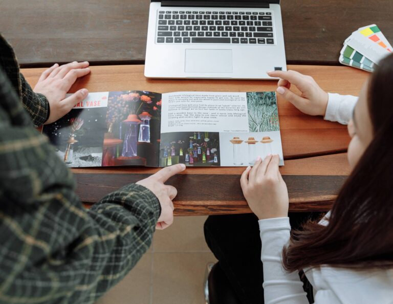 Two people looking at brochure examples together