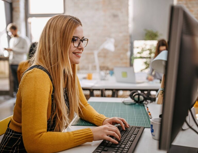 Woman using a business management system at her computer