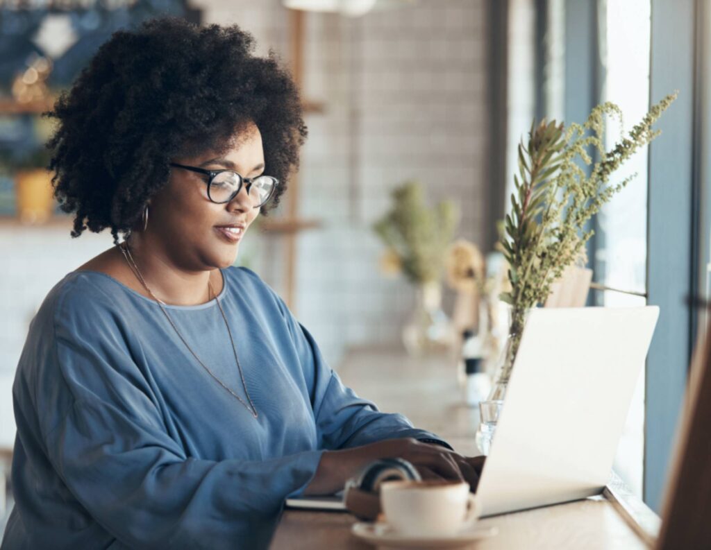 Woman at laptop working on email outreach