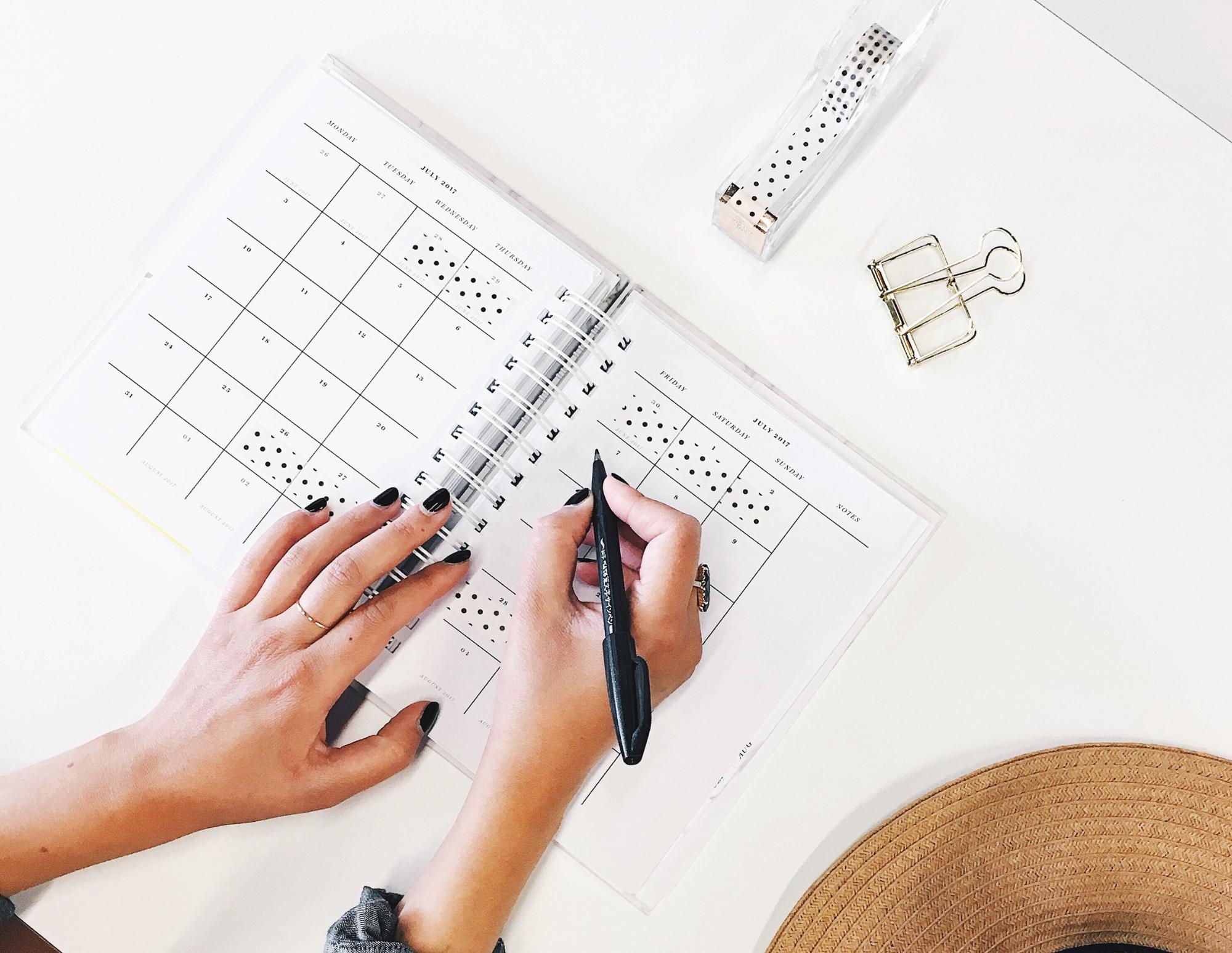 Women works on calendar booklet.