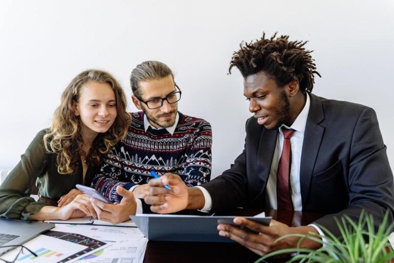 Three people reviewing sales email templates