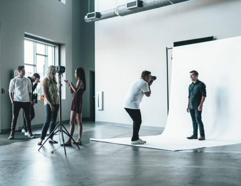 Photographer in a studio taking photos of people