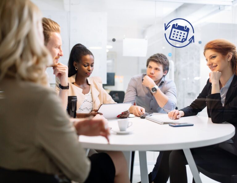 Team sitting around a table discussing round-robin scheduling