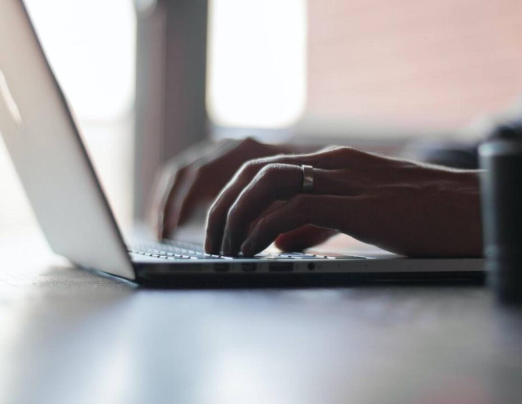 Person typing on laptop