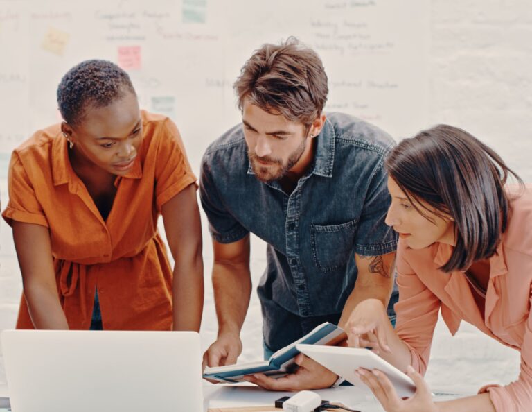 Three people meeting to discuss client onboarding