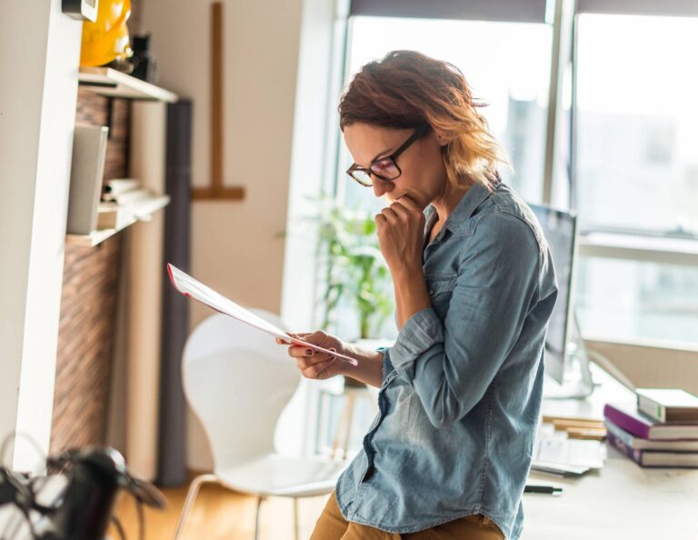 Woman reading through a client contract