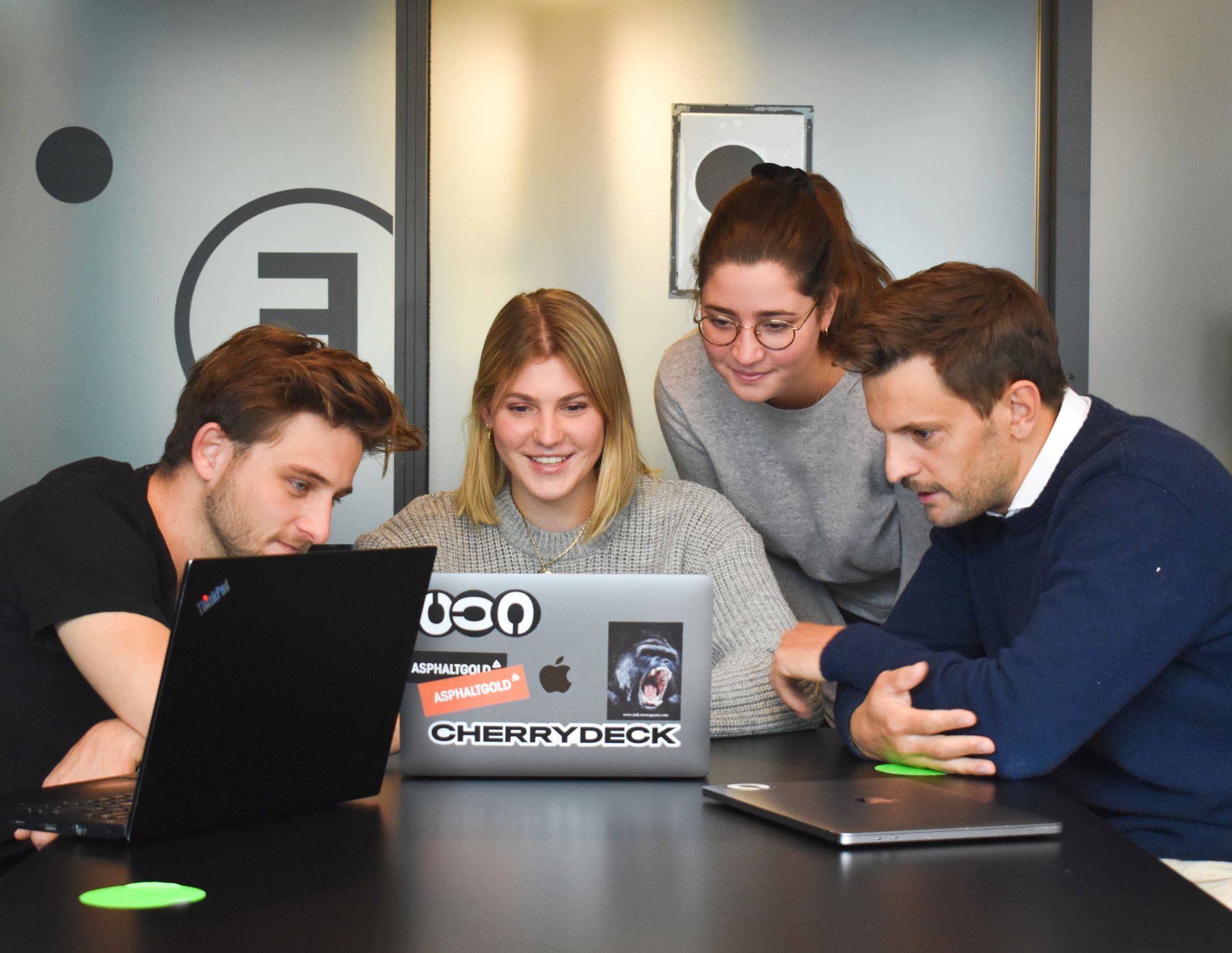 a client onboarding team looks at a laptop.