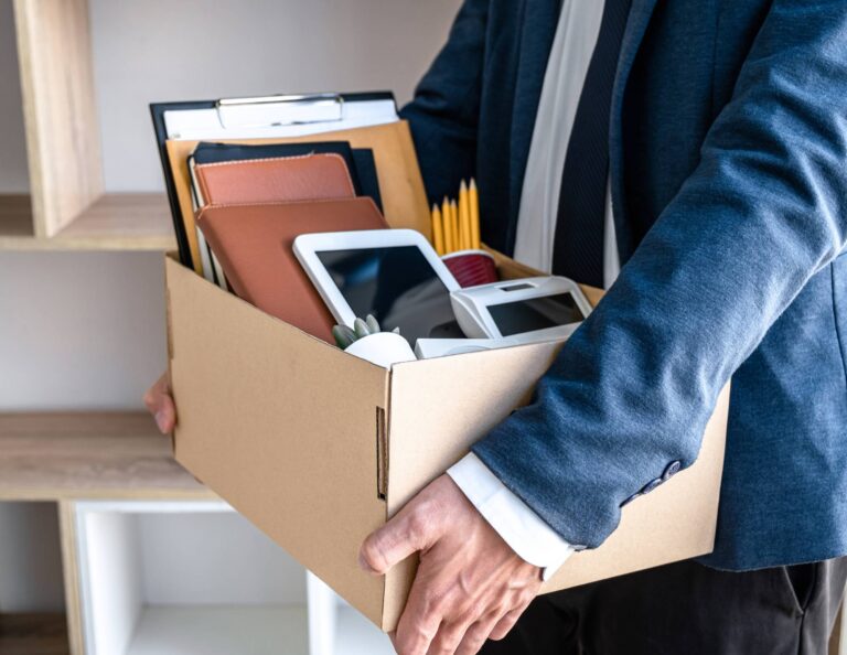 Man holding box of items after resigning