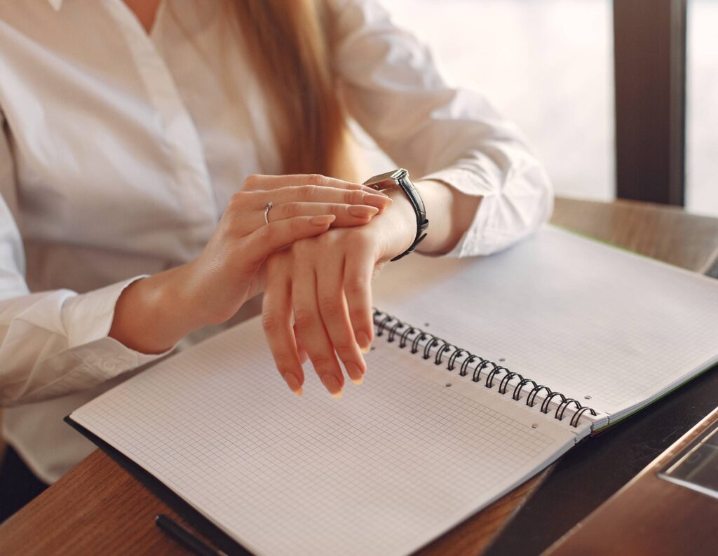 Woman checking her watch to manage her time properly