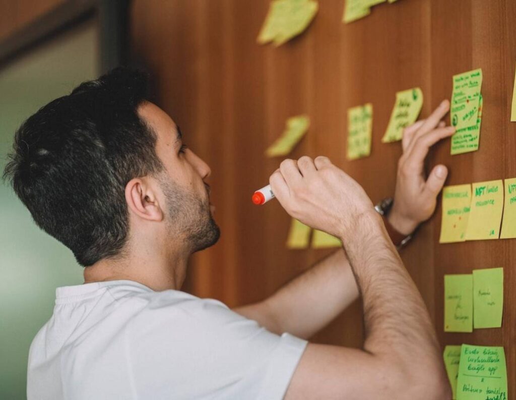 Man conducting a successful project discovery phase using sticky notes