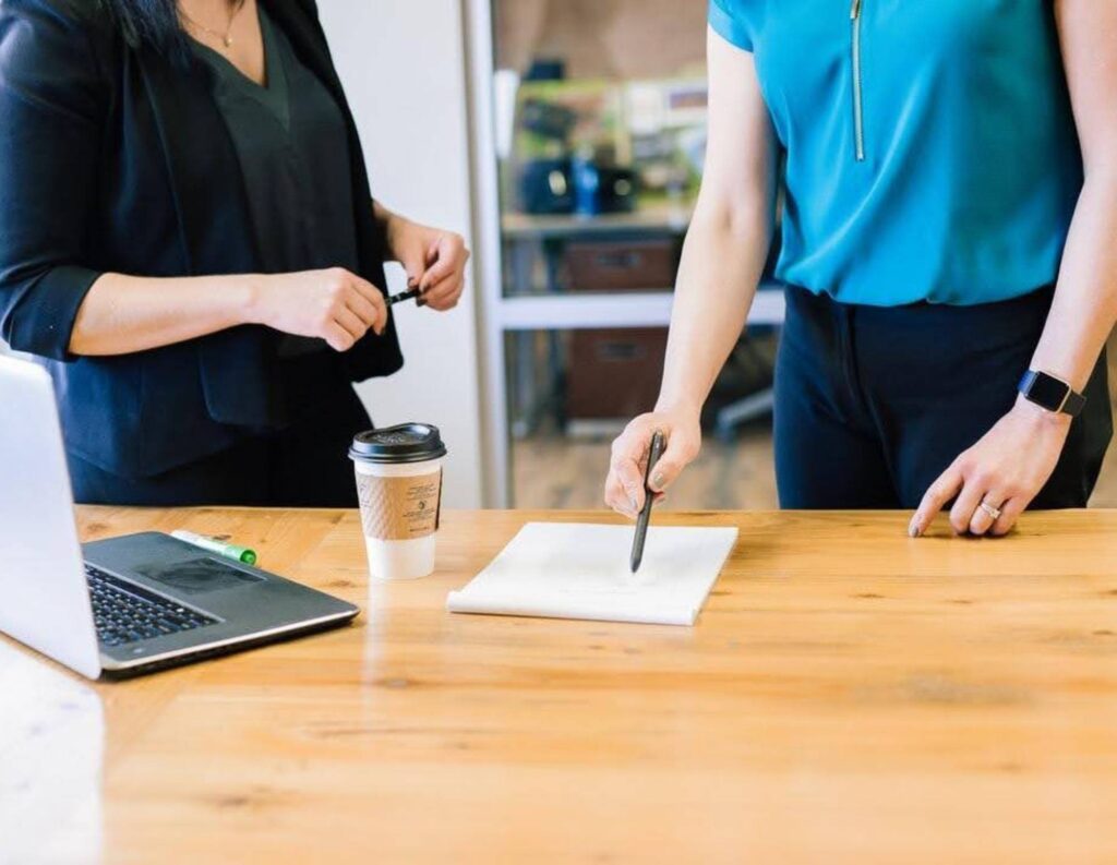 Two people working on creating a contract