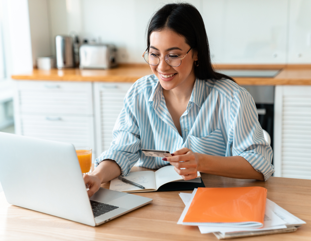 Person using credit card to make online payment.