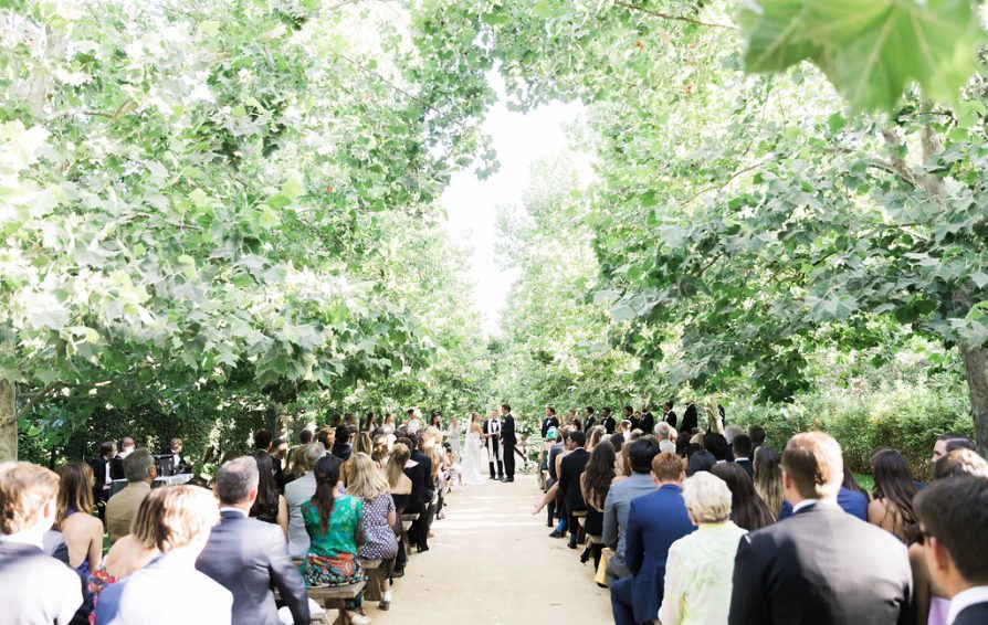 Couple getting married in an outdoor ceremony.