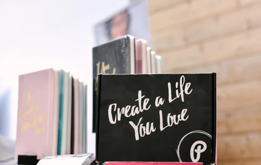 books in a window with a sign that says create a life you love and the pinterest logo