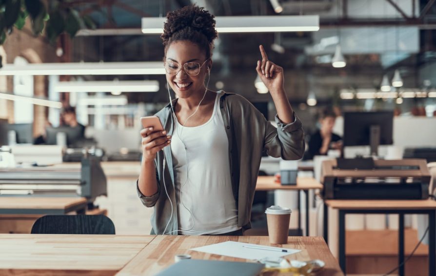 a woman on her phone learning how to write copy to win more clients via email