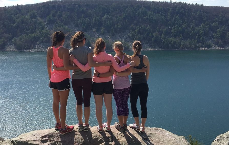 Group of woman with looking out over a lake.