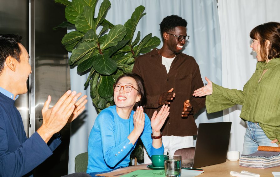 Excited business team celebrating in office