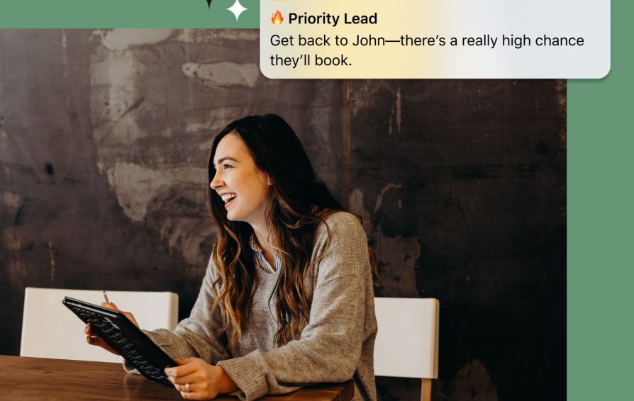 Woman laughs as she receives an AI notification about an incoming lead.