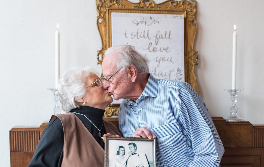 Couple kisses at their 65th anniversary photoshoot