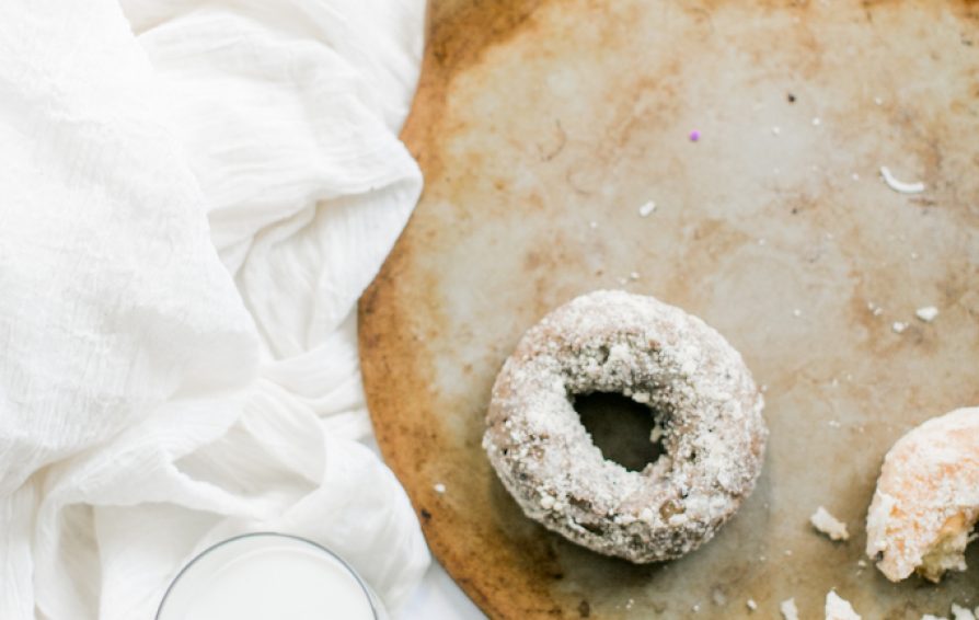 A styled shot of donuts with a glass of milk