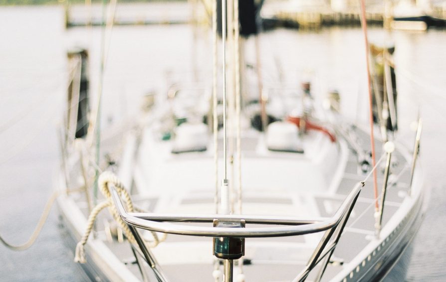 Close up on the bow of a sail boat on the water