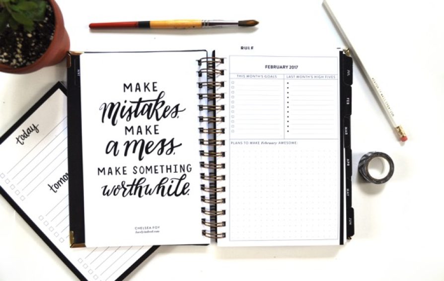 Open notebook with writing that reads, 
