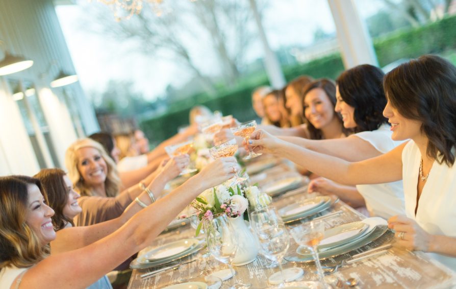 Woman at dinner party give a toast