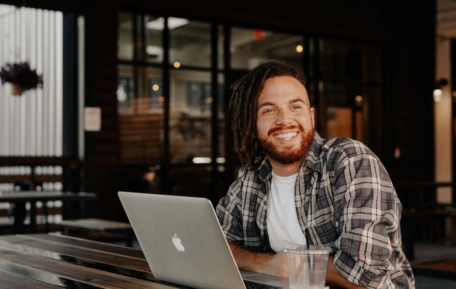 Smiling independent works at coffee shop.