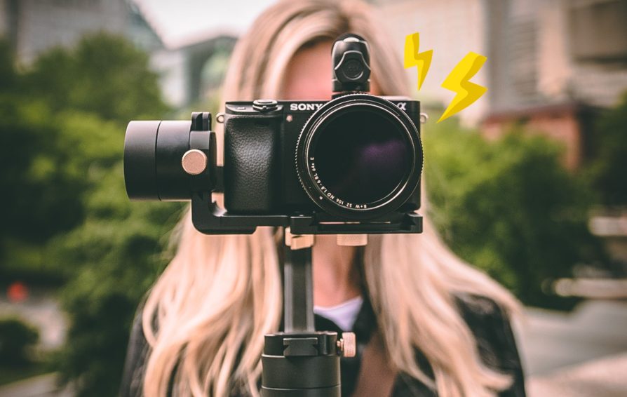 Person looks through camera filing footage for video marketing.