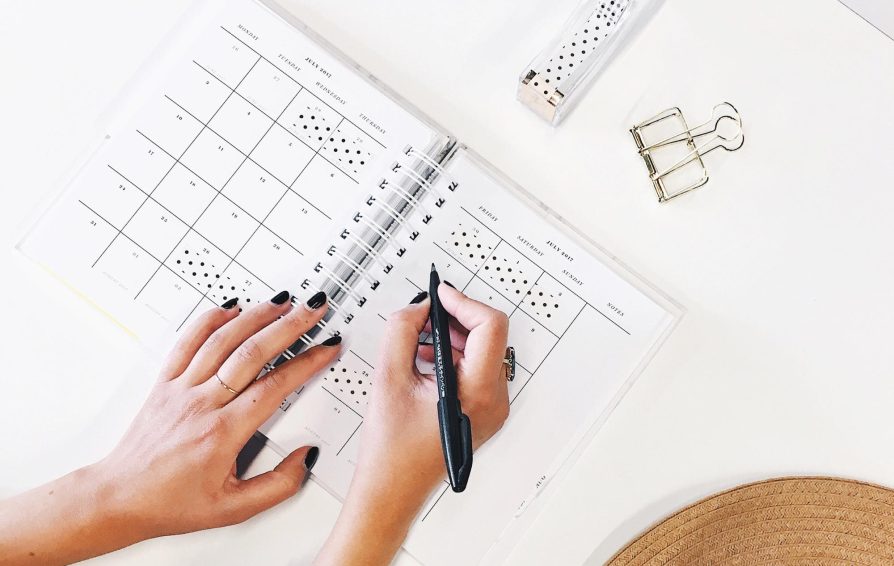 Women works on calendar booklet.