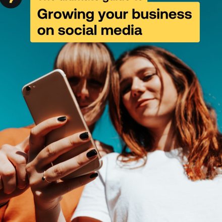 Growing your business on social media Two women look at a phone on the cover of Growing your business on social media guide.