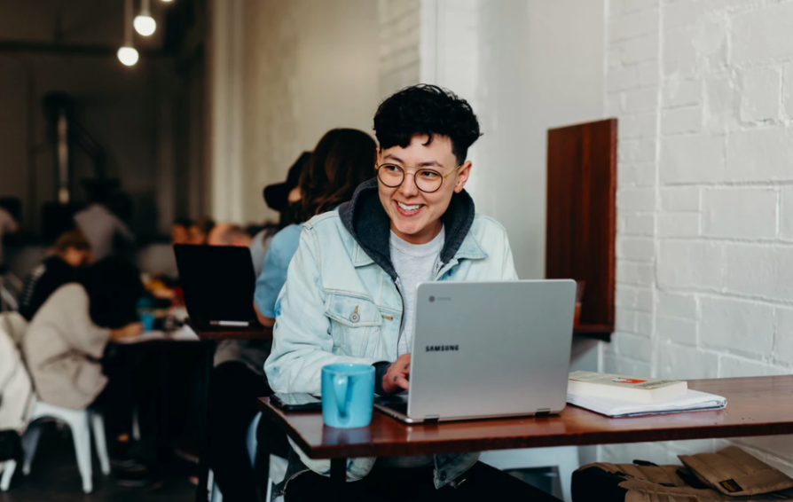 a woman on a laptop at a cafe learning how to optimize her portfolio site