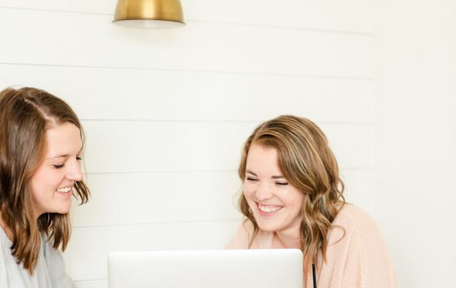 two women looking at a laptop and learning how to craft an evergreen sequence