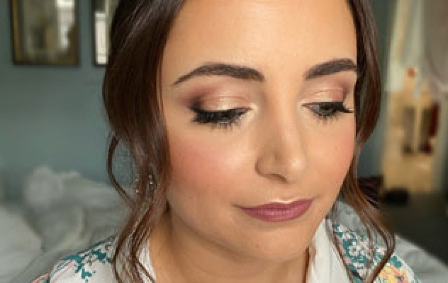 bride getting makeup work done for her wedding