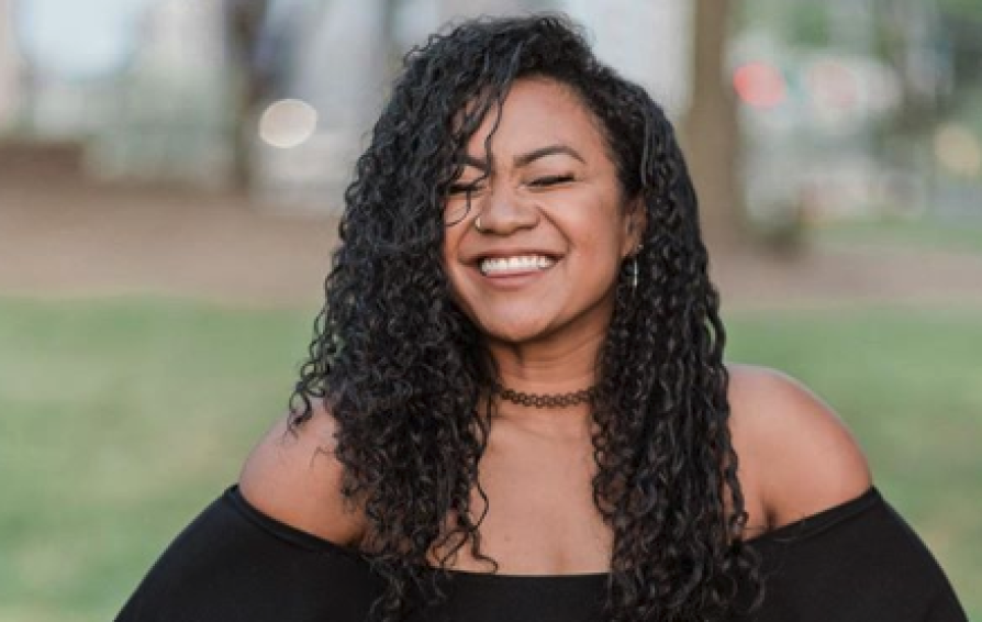 Close up of a woman smiling with her eyes closed.