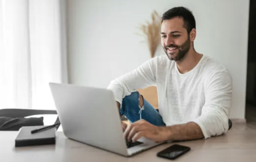 man looking at a laptop learning about year end metrics