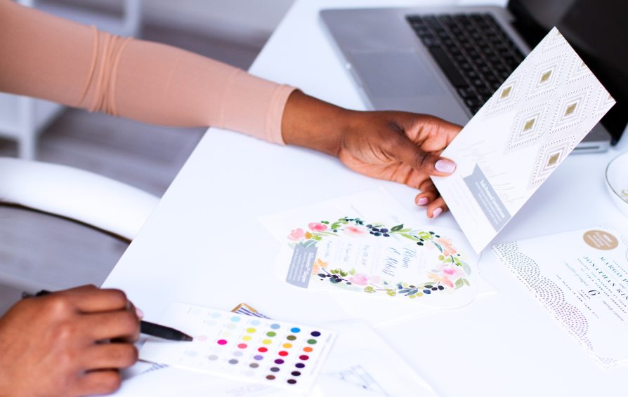Close up of a woman's hands working with colorful stationary
