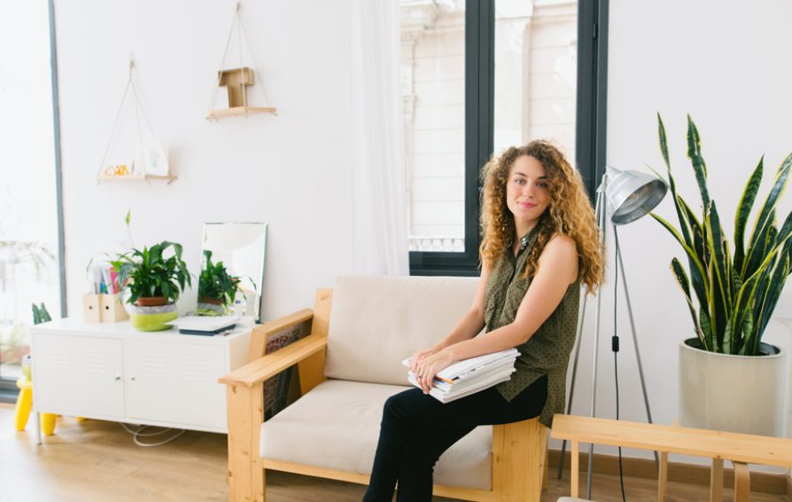 Freelancer sitting on chair with laptop