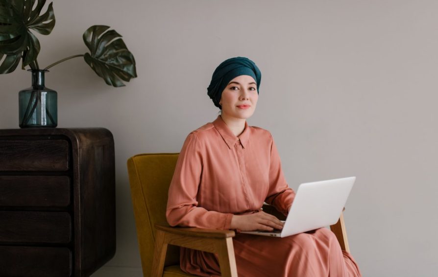 woman on a laptop learning how to evaluate roi of podcasts