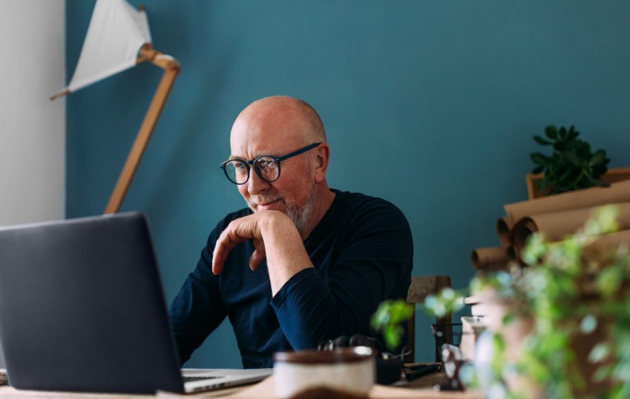 A fine-looking middle aged man working from his home office