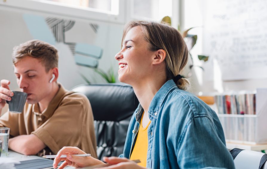 a man and woman at laptops learning 4 things business owners love to automate