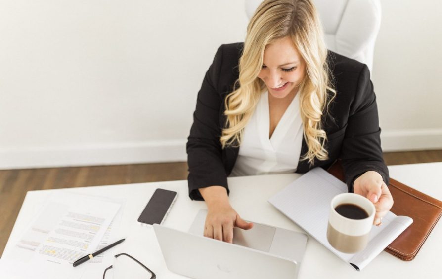 Woman sitting at the desk with a planner