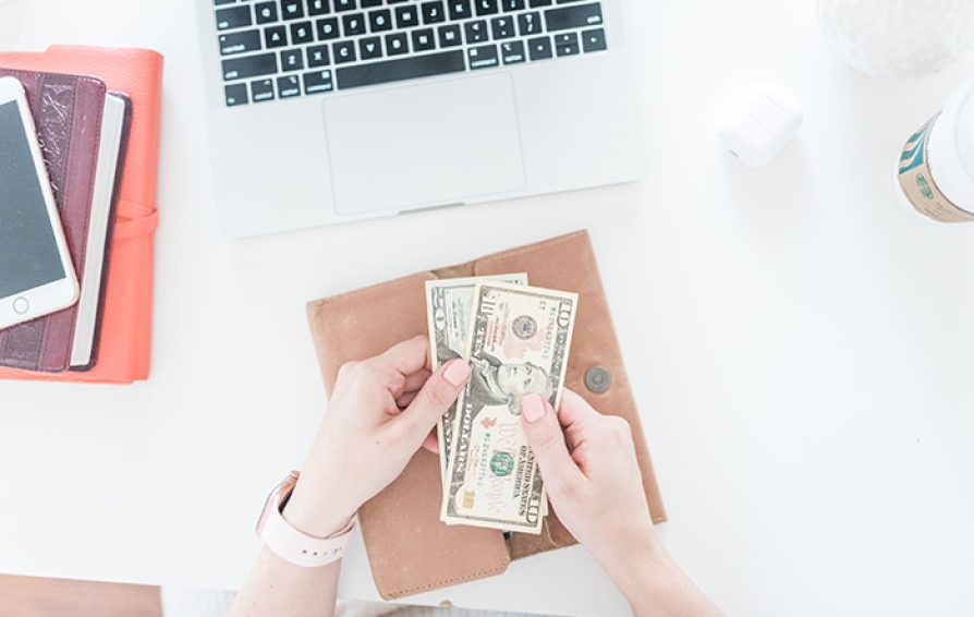 business owner handing money to cover expenses