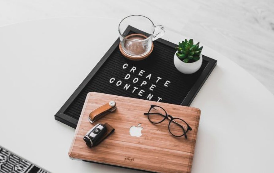 Pile of office supplies with a sign that reads 