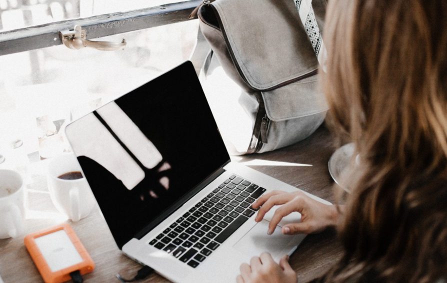 person searching for a mentor on their laptop