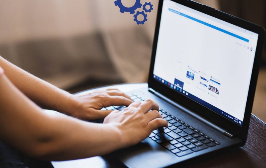 Person on laptop with gear illustration showing business process automation software